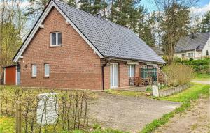 a red brick house with a roof at Awesome Home In Wittstock With Kitchen in Wittstock