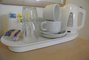 a kitchen counter with a coffee maker and a blender at Carlton Hotel in London