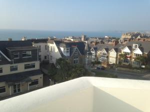 a view of a city with houses and the ocean at The White House Hotel in Newquay