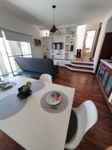 a living room with a white table and white chairs at Loft5 a solo 2 cuadras de la Costanera!!! in Corrientes +5 photos