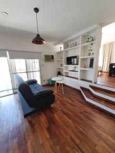 a living room with a couch and a table at Loft5 a solo 2 cuadras de la Costanera!!! in Corrientes