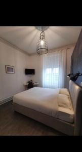 ein Schlafzimmer mit einem großen Bett und einem Fenster in der Unterkunft Les Portes d'Or in Nancy