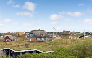 a group of houses with a grass roof at Fan Bad, Lejl, 69 in Fanø