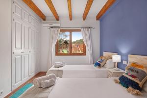a bedroom with two beds and a window at Villa Alyvos Pollensa - BY EMERALD STAY in Pollença