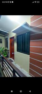 a building with red and white stripes on it at Kylitas transient house studio apartment 1st floor in Tagbilaran City
