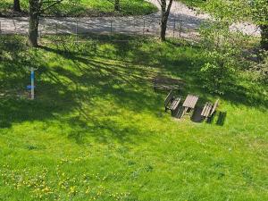 two benches sitting in the grass in a field at Dworcowa przy basenie in Olsztyn