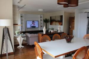 a living room with a white table and chairs at Casa Primavera by The Lodges in Campos do Jordão