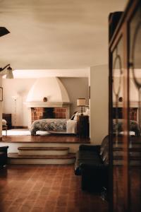 a bedroom with a bed and a fireplace at Le dimore de Il borgo del balsamico in Albinea