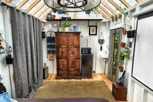 a room with a wooden cabinet in a tiny house at Stabbin Cabin #2 on Grant Island - Worlds Raddest Island in Glenfield