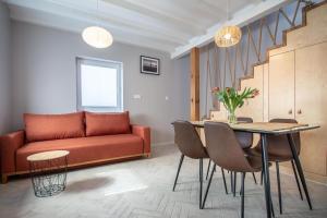 un soggiorno con divano, tavolo e sedie di Domki Apartamentowe - Na Makowej a Jastrzębia Góra