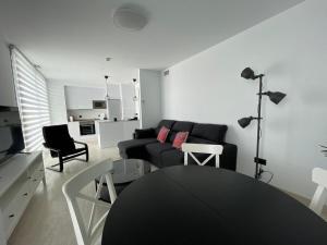 a living room with a couch and a table at LHOME CÁDIZ in Cádiz