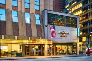 a building with an american flag in front of it at Residence Inn by Marriott New York Manhattan/Times Square in New York