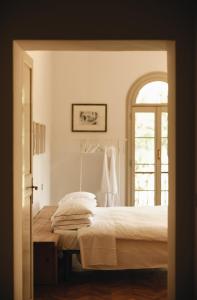 a bedroom with a bed and an open door at Le dimore de Il borgo del balsamico in Albinea
