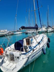 a white sail boat docked in a harbor at boat and breakfast in Bari