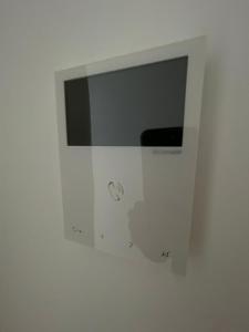 a white bathroom with a mirror on a wall at LHOME CÁDIZ in Cádiz