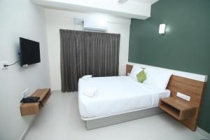 Postel nebo postele na pokoji v ubytování Hotel Royal Blooms