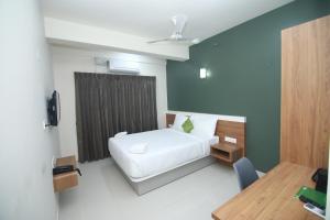 Postel nebo postele na pokoji v ubytování Hotel Royal Blooms