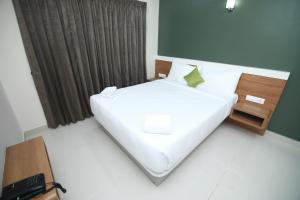 Postel nebo postele na pokoji v ubytování Hotel Royal Blooms