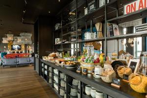 a store with a display case filled with food at Motel One Mannheim in Mannheim