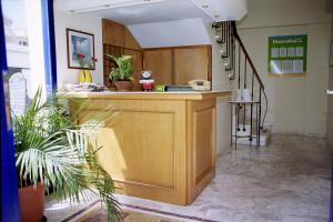 a room with a counter and a staircase with plants at Nea Elena Apartments in Chania