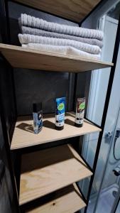 a shelf in a bathroom with two products on it at WUDINO - Ubytování v přírodě, se zvířaty v industriálním duchu, in Ostrov u Macochy