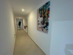 a hallway with a large painting on the wall at LHOME CÁDIZ in Cádiz