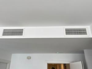 two air conditioning vents in a white ceiling at LHOME CÁDIZ in Cádiz