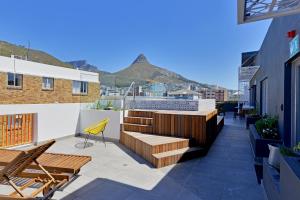 a balcony with stairs and chairs on a building at SixOnN Luxury Apartments by Elevate in Cape Town