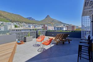 a balcony with chairs and a view of a city at SixOnN Luxury Apartments by Elevate in Cape Town