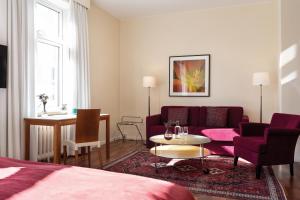 a living room with a couch and a table at Elite Stadshotellet Växjö in Växjö