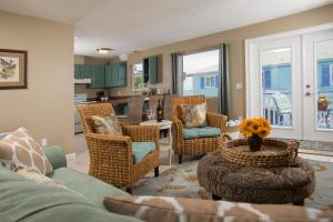 a living room with a couch and chairs and a kitchen at Bayfront Marin House in St. Augustine