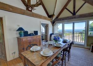 a dining room with a wooden table and chairs at Ferndale House Lynmouth in Lynmouth