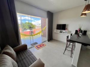 a living room with a view of a pool at VilaMar Jacuípe in Camaçari