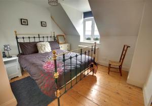 a bedroom with a bed and a chair at Ferndale House Lynmouth in Lynmouth