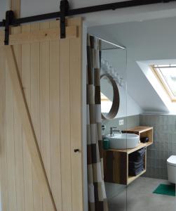 a bathroom with a shower door and a sink at Ausblick Maisenbach in Bad Liebenzell
