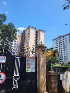 a black fence with signs on it with tall buildings at Cozy Studio Stay Kilimani Valley Acarde Area in Nairobi