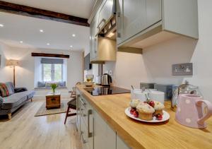 uma cozinha com um balcão com um prato de queques em Fox Cottage em Lynmouth