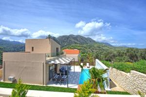 a villa with a view of the mountains at Villa Silentium Ionia by PosarelliVillas in Aryiroúpolis