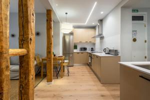 a kitchen and dining room with a table at 2 bedrooms 2 bathrooms furnished - Las Letras - Modern - MintyStay in Madrid