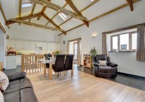 a living room with a couch and chairs and a table at The Granary Muddiford in Shirwell