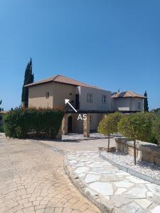a house with a driveway in front of it at Aphrodite Hills Adonis Apartment in Kouklia