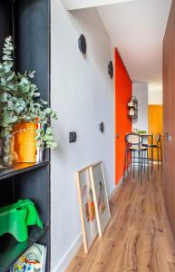 a hallway with an orange door and a dining room at Cozy Bright - 1Bedroom 1 Bathroom - La Latina in Madrid