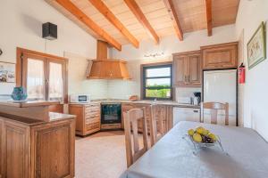 a kitchen with a table with a bowl of fruit on it at Ca Na Neus in Pollença