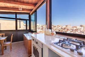 Una cocina con estufa y vista a la ciudad. en Appartamento Il Belvedere - MyHo Casa, en Vieste 13 fotos más