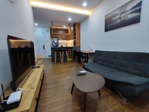 a living room with a couch and a table at Family-Friendly 2BR Apartment , Cozy Room near MITEC Malaysia , Arte Mont Kiara in Kuala Lumpur