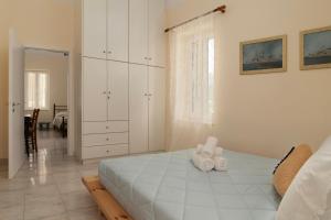 a bedroom with a bed with two towels on it at Theros Home Andros in Andros