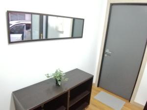 a mirror and a table in a room with a door at Hello Home Canillas in Madrid
