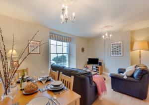 a living room with a table and a dining room at Harbour Heights Ilfracombe in Ilfracombe