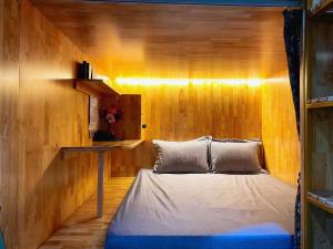a bedroom with a bed and a wooden wall at Sky Homestay Ha Giang in Ha Giang