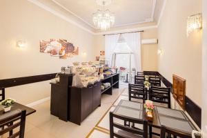 a restaurant with tables and chairs in a room at Hotel Annabella Roof Terrace in Florence